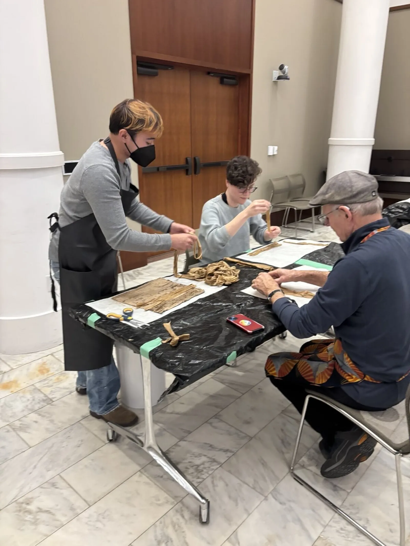 An instructor cuts wet fibers for participant use.